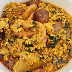 A picture of Egusi soup with vegetable.