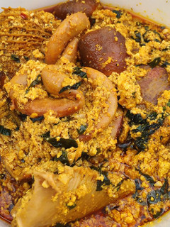 A picture of Egusi soup with vegetable.