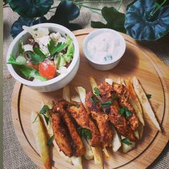 A picture of Greek Chicken with yogurt dip.