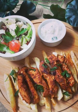 A picture of Greek Chicken with yogurt dip.
