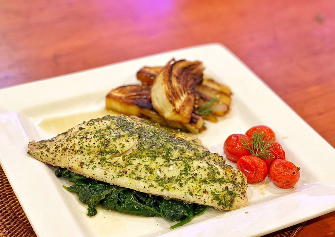 Herb - Baked Sea bass, Caramelised Fennel, Baby Tomatoes and Spinach with Lemon Herb Butter