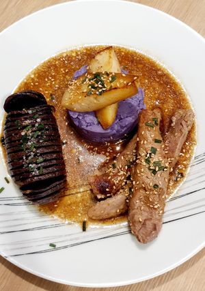 A picture of Duck Tenders with Honey, Balsamic Vinegar, and Sesame, Vitelotte Potatoes Two Ways: Fan-Roasted and Mashed.