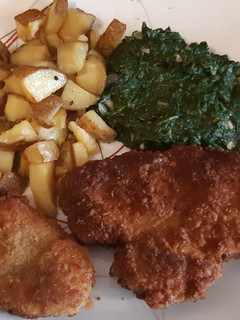 A picture of Schnitzel with oven roasted potatoes.