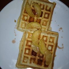 A picture of Honey drizzled waffles with sauteed apples.