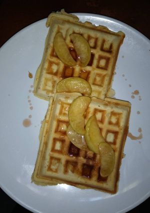 A picture of Honey drizzled waffles with sauteed apples.