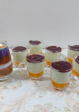 A picture of Fruit custard with orange jelly and strawberry palm sauce.