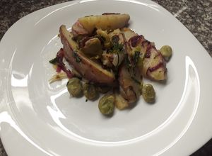 Una foto de Papas salteadas en gajos con habas