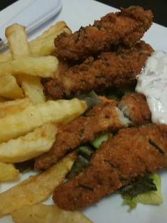 A picture of Fish fingers with fries and tartar sauce.