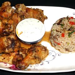 A picture of Broiled marinated chicken wings with blue cheese dip.