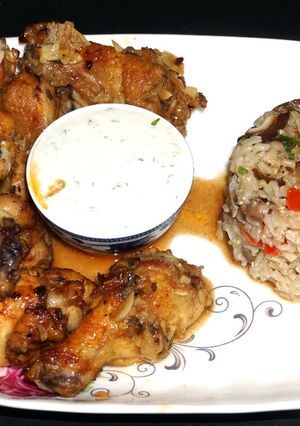 A picture of Broiled marinated chicken wings with blue cheese dip.