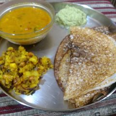 A picture of Bread and cooked rice masala dosa with sambhar and chutney.