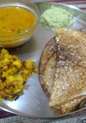 A picture of Bread and cooked rice masala dosa with sambhar and chutney.