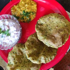 A picture of Bajra methi Puri with mutter shallot and raita.
