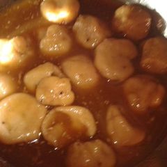 A picture of Lothani (sweet rice balls dipped in jaggery syrup).