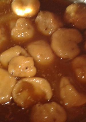 A picture of Lothani (sweet rice balls dipped in jaggery syrup).