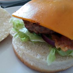 A picture of Pork and Apple burger with Cheddar and mustard mayo.