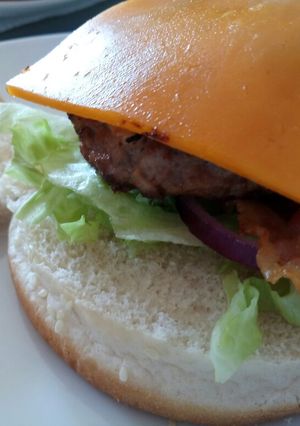A picture of Pork and Apple burger with Cheddar and mustard mayo.
