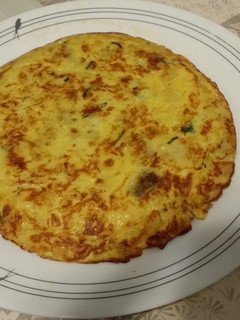 Una foto de Tortilla de patatas con calabacín y cebolla