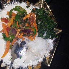 A picture of Fried terere with boiled rice and veggies Fried in ghee.