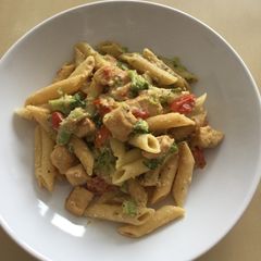 A picture of Broccoli, tomatoes pennes pasta.