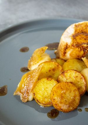 A picture of Chicken Ballotine, Pan-Fried Potatoes, Apple Compote, and Crispy Chicken Skin Chips.