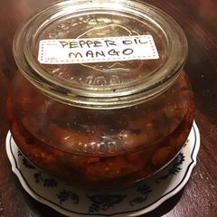 A picture of California Farm Green Mangos Pickled in Pepper Oil.