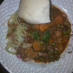 A picture of Beef stew and steamed cabbage.