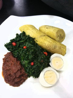 A picture of Unripe plantain with tomato sauce,vegetable and egg.