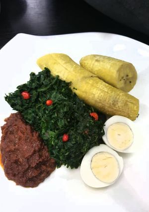 A picture of Unripe plantain with tomato sauce,vegetable and egg.