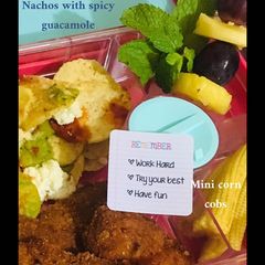 Nachos, crumbed chicken pieces, mini corn cobs, pineapple grape and mint fruit skewer A picture of Nachos, crumbed chicken pieces, mini corn cobs, pineapple grape and mint fruit skewer.