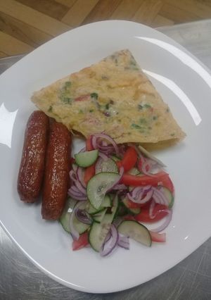 A picture of Spanish Omellette, deep fried sausages n cucumber onions salad.