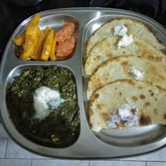 A picture of Makki ki Roti with Sarson ka Saag and chatpata mooli galgal achar.