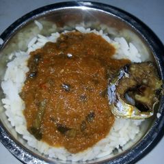 A picture of Rice and stew with fish.