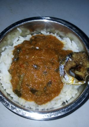 A picture of Rice and stew with fish.