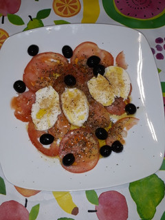 Una foto de Carpaccio de tomate con motsarella marinada con especias
