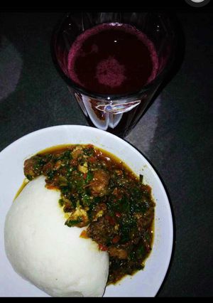 A picture of Pounded yam wit vegetable soup nd zobo drink.