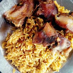 Fried chicken with Traditional Jollof rice(with Locust beans) A picture of Fried chicken with Traditional Jollof rice(with Locust beans).