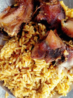 A picture of Fried chicken with Traditional Jollof rice(with Locust beans).