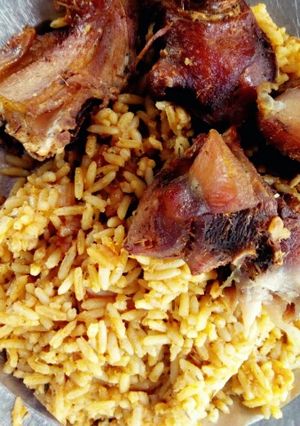A picture of Fried chicken with Traditional Jollof rice(with Locust beans).