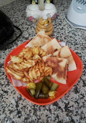 A picture of Meat Sandwiches with fries.