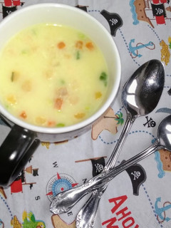 A picture of Vegetable sweet corn soup with croutons.