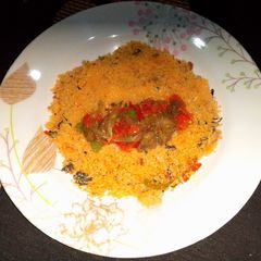 A picture of Dambun shinkafa with Shredded mutton and vegetables sauce.