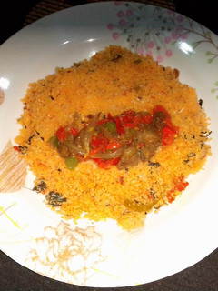 A picture of Dambun shinkafa with Shredded mutton and vegetables sauce.