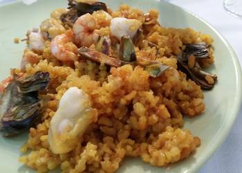 Popular Cuisine Seafood paella with artichokes Most Delicious