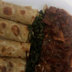 A picture of Beef stew,greens with chapati.