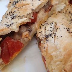 A picture of Spicy chicken and tomato puff pie.