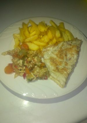 A picture of Potatoes, omelette and vegetables sauce.