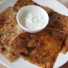 A picture of Potato coriander paratha with curd.