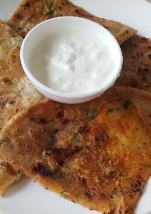 A picture of Potato coriander paratha with curd.