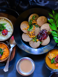 A picture of Multigrain Idli, Garlic Chutney, Coconut Chutney, Sambhar.